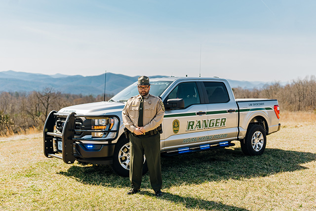 Law enforcement ranger with park visitor