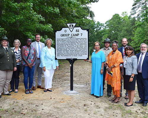 Group Camp 7 historical highway marker Group around the Group Camp 7 historical marker